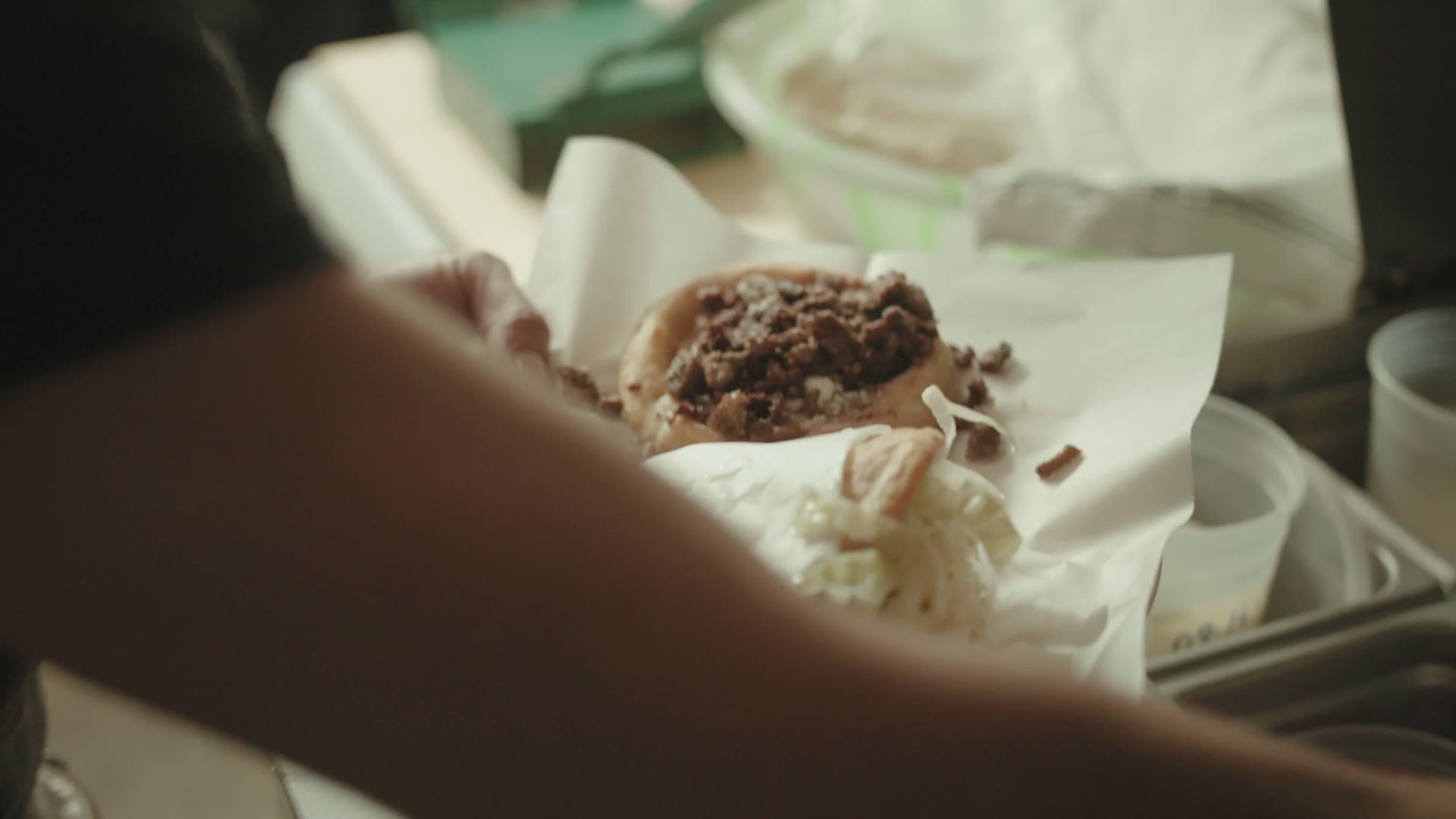 A fresh-made torta being handed across the counter at Lala’s food truck